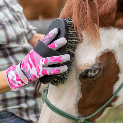 Horse being brushed using Dig It® Handwear Garden Gloves in Pink Camo.
