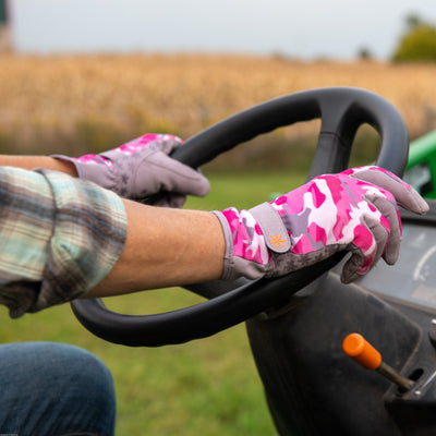 Tractor being driven with Dig It® Handwear Garden Gloves in Pink Camo